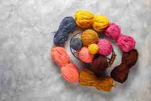 Free photo balls of yarn in different colors with knitting needles.