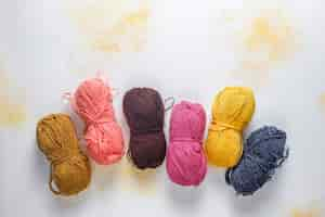 Free photo balls of yarn in different colors with knitting needles.