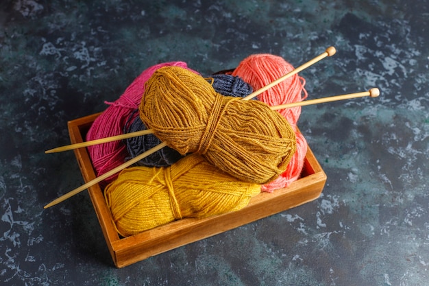 Free photo balls of yarn in different colors with knitting needles.