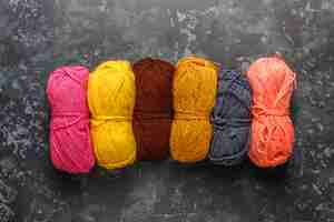 Free photo balls of yarn in different colors with knitting needles.