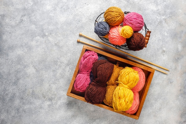 Free photo balls of yarn in different colors with knitting needles.