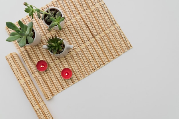 Free photo bamboo table runner with plants and candles