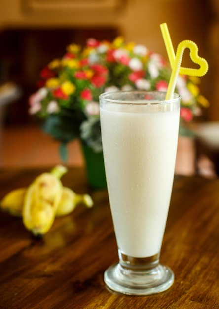 Banana milk shake on the wooden background