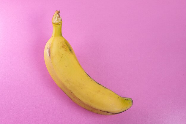 Banana on the pink surface