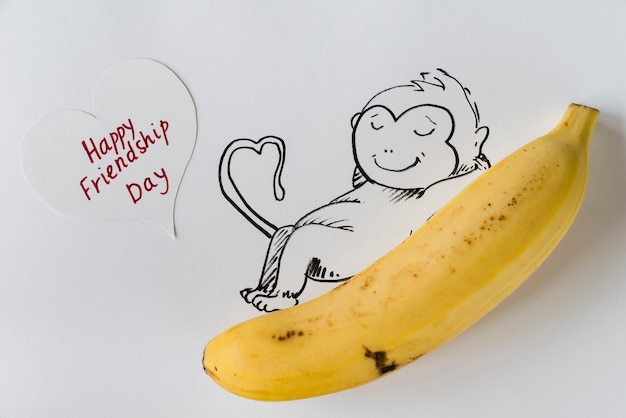 Free Photo banana with painted monkey and greeting card