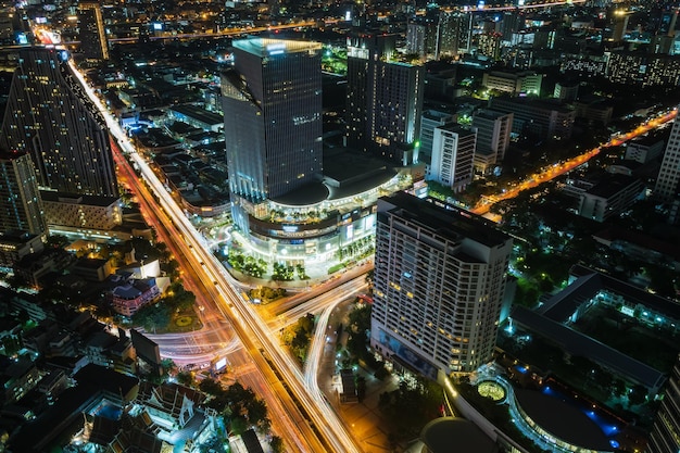 Bangkok business district city center above Samyan intersection and traffic with buildings and skyscrapers during night