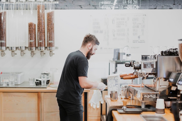 Bar concept with barman making coffee