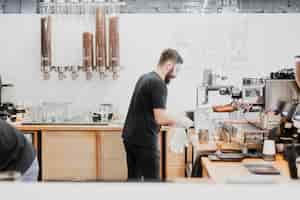 Free photo bar concept with barman making coffee