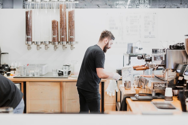 Bar concept with barman making coffee