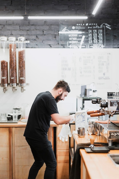 Free photo bar concept with barman making coffee