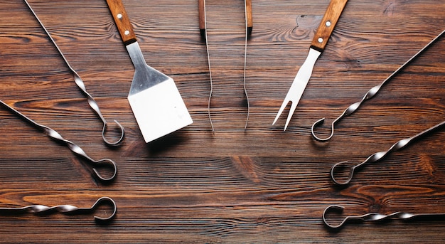 Barbecue utensil set on wooden table