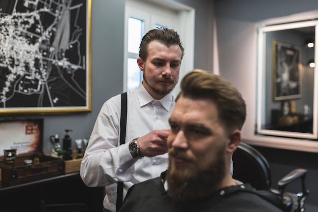 Barber serving bearded client