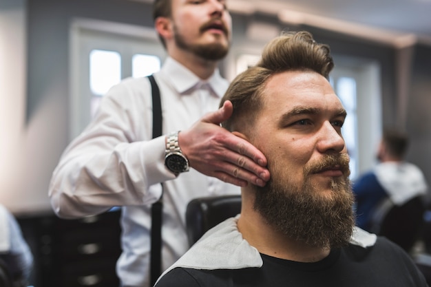 Barber showing result to client