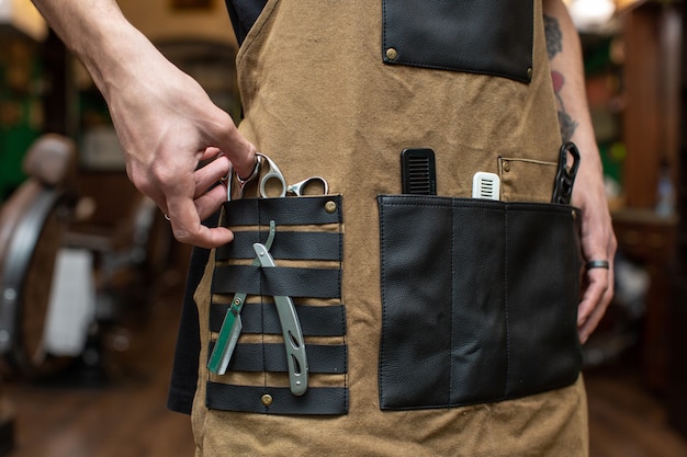 Barber with various tools in his pockets