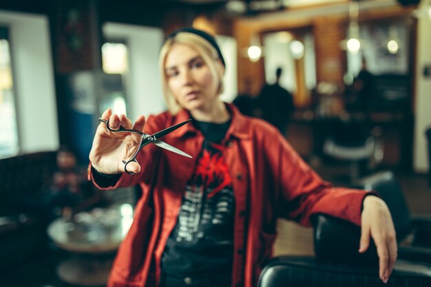 Barbershop. Female barber at salon. Gender equality