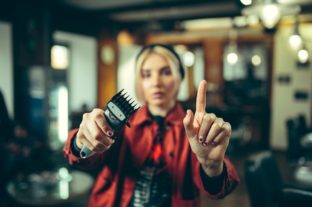 Barbershop. Female barber at salon.