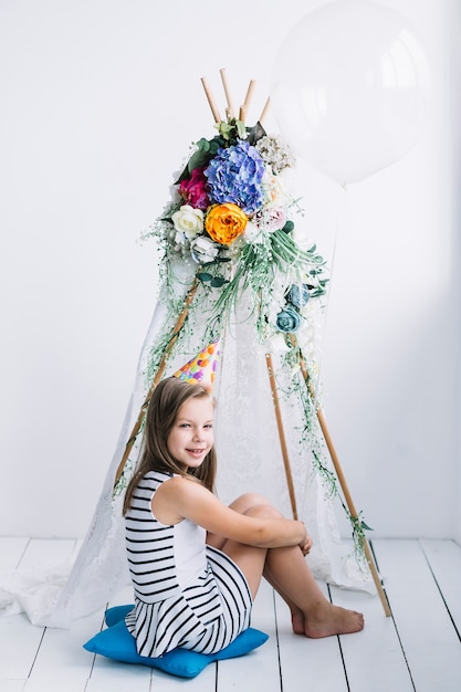 Free photo barefoot girl with balloon near tent on birthday party