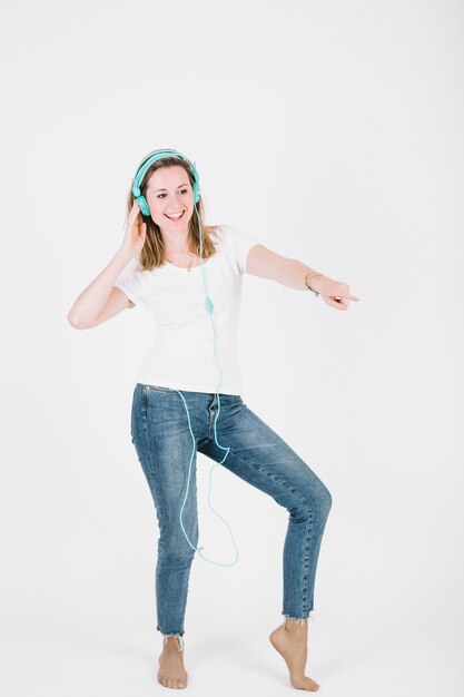 Barefoot woman listening to music and dancing