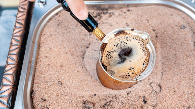 Free Photo a barista making coffee on the sand in istanbul turkey