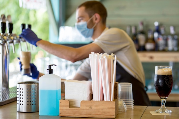 Free photo barista male at work with mask