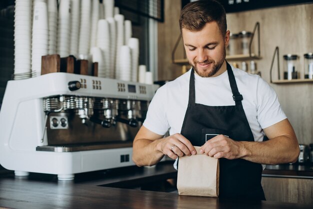 Barista packing take away snacks at a coffee shop