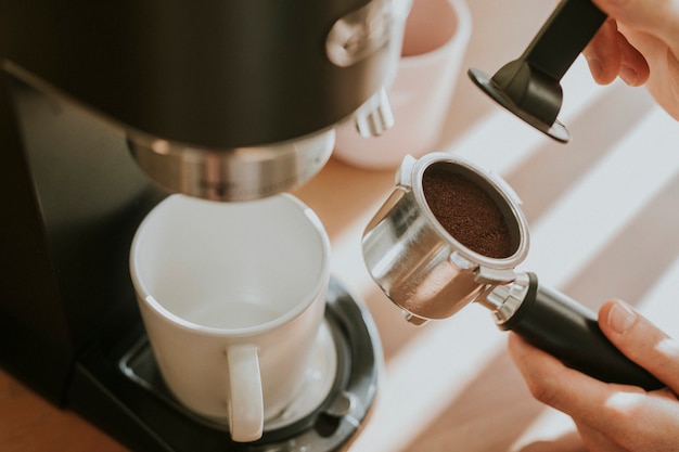 Free Photo barista pressing ground coffee in a filter coffee of machine