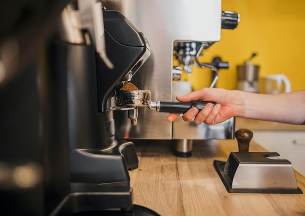 Barista using coffee machine at shop