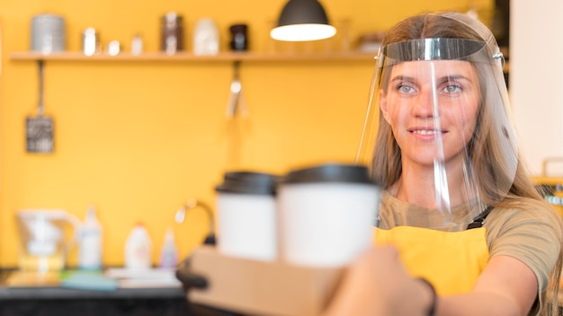 Barista wearing face protection when serving