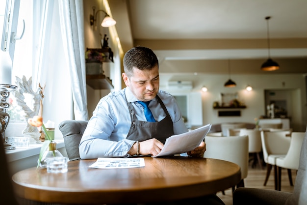 Barman looking at menu