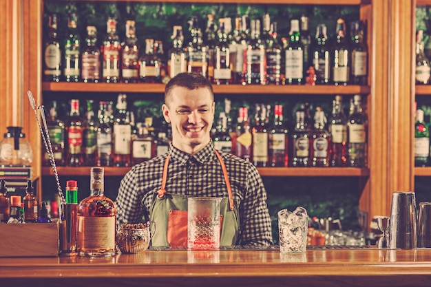 Free photo barman offering an alcoholic cocktail at the bar counter on the bar