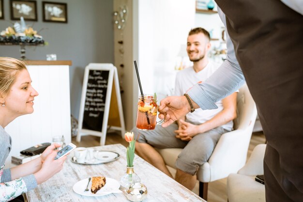 Barman serving cocktail