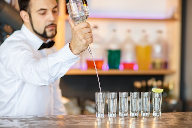 Barman at work, preparing cocktails.