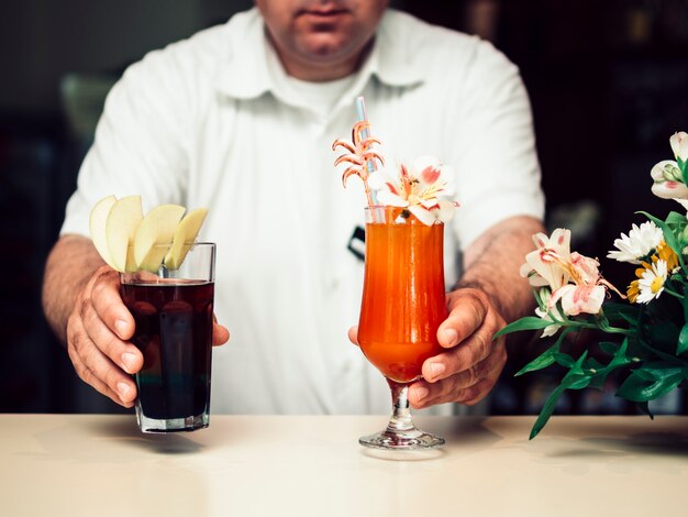 Bartender giving alcoholic cocktails