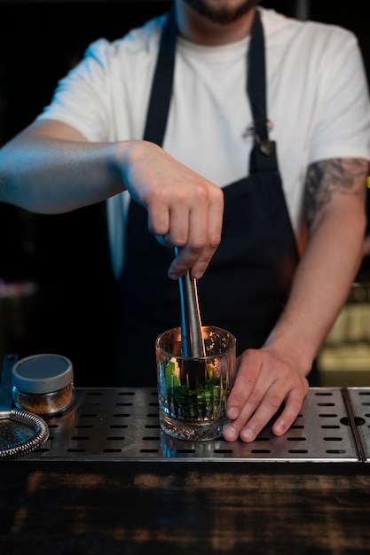 Free Photo bartender making a delicious cocktail