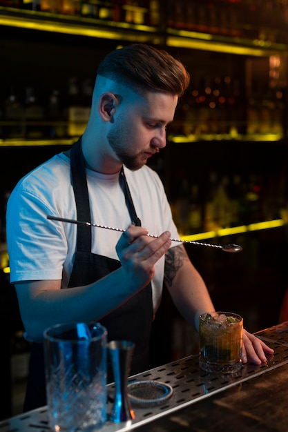 Free Photo bartender making a delicious cocktail