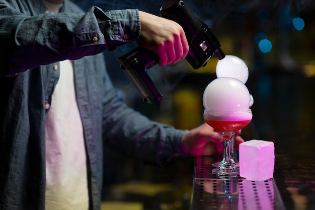 Free Photo bartender making a refreshing cocktail