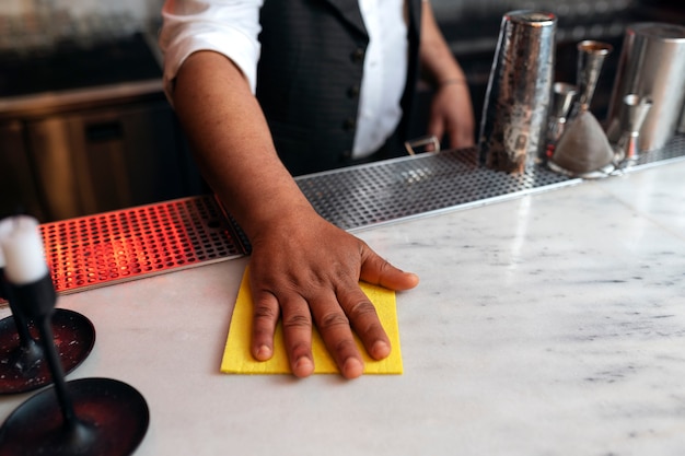 Free photo bartender preparing drink at bar