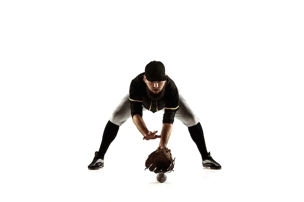 Free photo baseball player, pitcher in a black uniform practicing and training isolated on a white background.