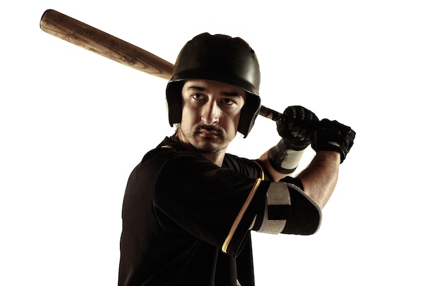 Free photo baseball player, pitcher in a black uniform practicing and training isolated on a white background.