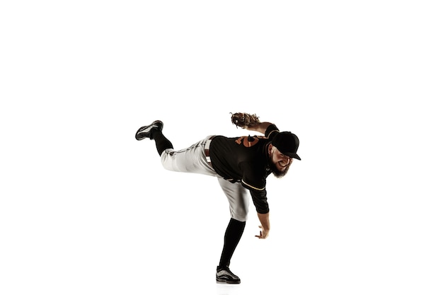 Free photo baseball player, pitcher in a black uniform practicing and training isolated on a white background.