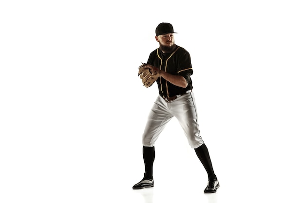 Free photo baseball player, pitcher in a black uniform practicing and training isolated on a white wall. young professional sportsman in action and motion. healthy lifestyle, sport, movement concept.