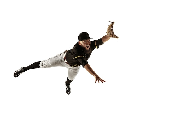 Free photo baseball player pitcher in a black uniform practicing on a white wall