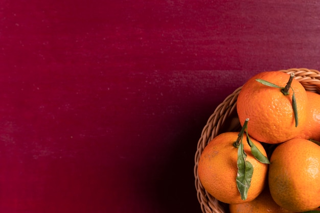 Basket of tangerines on red background for chinese new year