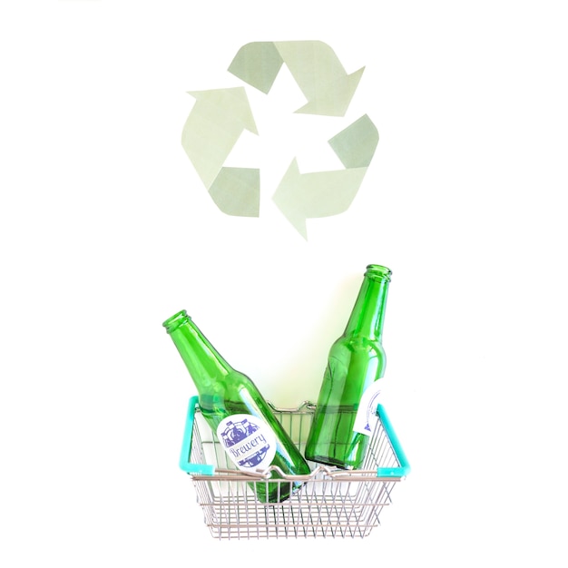 Free photo basket with bottles near recycle symbol