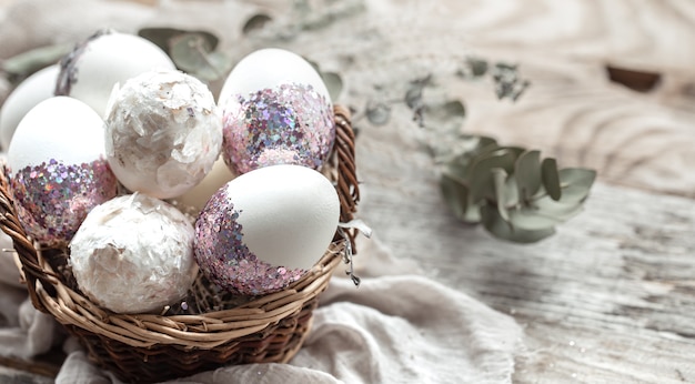 Free photo basket with eggs and dried flowers. an original idea for decorating easter eggs.