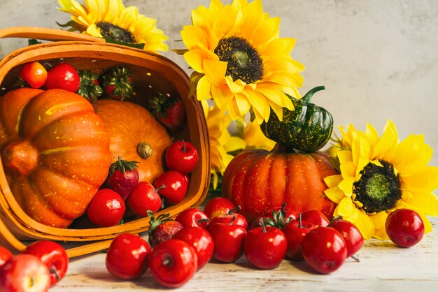 Basket with harvest near sunflowers