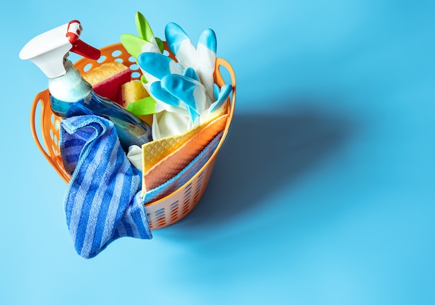 Basket with a set of accessories for cleaning. Sponges, rags, detergent and gloves  background