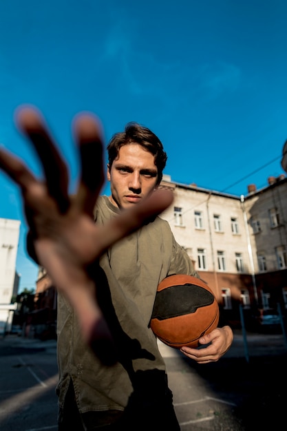 Free Photo basketball player covering camera with hand