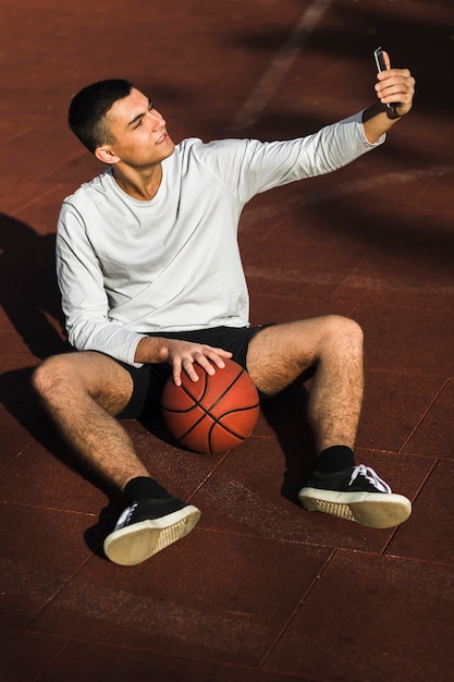 Free Photo basketball player taking a selfie