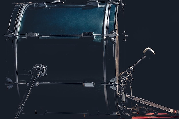 Free photo bass drum with pedal musical instrument on black background